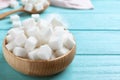 Refined sugar cubes in bowl on blue wooden table Royalty Free Stock Photo