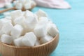 Refined sugar cubes in bowl on blue wooden table, closeup Royalty Free Stock Photo