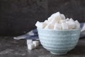 Refined sugar cubes in bowl on grey table Royalty Free Stock Photo