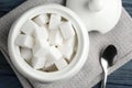 Refined sugar cubes in ceramic bowl on blue wooden table, top view Royalty Free Stock Photo