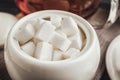 Refined sugar cubes in ceramic bowl on table, closeup Royalty Free Stock Photo