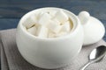 Refined sugar cubes in ceramic bowl on table, closeup Royalty Free Stock Photo