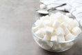 Refined sugar cubes in glass bowl on table. Space for text Royalty Free Stock Photo