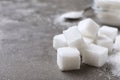 Refined sugar cubes on grey table, closeup. Space for text Royalty Free Stock Photo