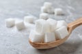 Refined sugar cubes in spoon on light grey table, closeup Royalty Free Stock Photo