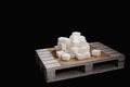 Pile of refined sugar cubes on wooden plate Royalty Free Stock Photo