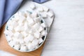 Refined sugar cubes on white wooden table, flat lay. Space for text Royalty Free Stock Photo