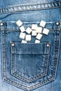 Refined sugar on denim background. Pocket of jeans full of refined sugar. Diet concept. Pocket full of sugar as symbol Royalty Free Stock Photo