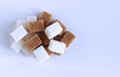 Refined white sugar and brown cane on a white background. Royalty Free Stock Photo