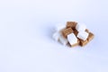 Refined white sugar and brown cane on a white background. Royalty Free Stock Photo