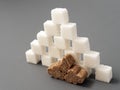 Refined sugar lump white and cane on a gray background Royalty Free Stock Photo