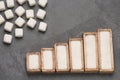 Refined white sugar powder and cubes. Statistical table of sale and consumption. Top view Royalty Free Stock Photo