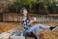 Refined white woman in stylish casual clothes spending time at countryside in autumn day. Outdoor photo of graceful lady