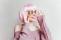 Refined young white girl in sparkle glasses and purple woolen sweater posing on light background. Studio portrait of