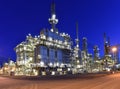 Refinery - chemical factory at night with buildings, pipelines and lighting - industrial plant