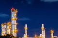 Refinery oil and gas industry at night blue sky after sunset time with chemical and petroleum for energy of transportation and Royalty Free Stock Photo