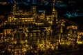 Refinery pipes and buildings with lights at night