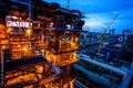 Refinery pipes and buildings with lights at night