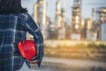 Refinery plant woman worker oil petrochemical industry hand holding red worker hard hat. Woman Emergency workers hands holding Royalty Free Stock Photo