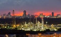 Refinery power plant with city downtown background during sunset Royalty Free Stock Photo
