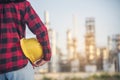 Refinery woman worker oil petro industry hand hold yellow worker helmet hard hat. Woman worker hands holding hardhat yellow work Royalty Free Stock Photo