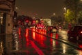 The reflecion of traffic and lights in the wet streets of london during night with bright and illuminated road Royalty Free Stock Photo