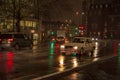 The reflecion of traffic and lights in the wet streets of london during night with the headlights of vehicles Royalty Free Stock Photo