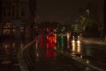 The reflecion of traffic and lights in the wet streets of london during night with vehicles on the road Royalty Free Stock Photo
