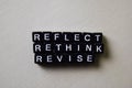 Reflect - Rethink - Revise on wooden blocks. Business and inspiration concept