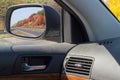 Reflected highway in car side rear-view mirror in autumn Royalty Free Stock Photo
