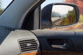Reflected highway in car side rear-view mirror in autumn Royalty Free Stock Photo
