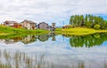 Reflected houses in the Lake Lod near the village of Chamois in Val D`Aosta, Italy.