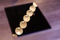 Reflected Lighted white paper lamps on ceiling on black electric stove on wooden table