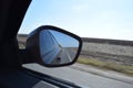 Reflected road in rearview mirror. View from car side mirror driving on asphalt road Royalty Free Stock Photo