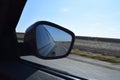 Reflected road in rearview mirror. View from car side mirror driving on asphalt road Royalty Free Stock Photo