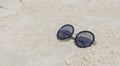 Reflecting sunglasses on the beach, glasses in the sand