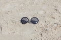 Reflecting sunglasses on the beach, glasses in the sand