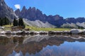 Reflection of Alpine peaks of Odle Group at Geisler Alm, Dolomites Italy