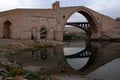 Reflection in the Batman River of Malabadi bridge near the city of Silvan, Turkey