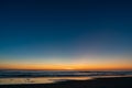 Reflection of blood red sunset on the wet sand on the beach and dark horizon line Royalty Free Stock Photo