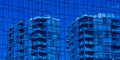 Reflection of a blue coloured highrise in the windows of another building Royalty Free Stock Photo