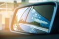 Reflection of blue sky on car side mirror Royalty Free Stock Photo