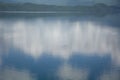 Reflection of blue sky and clouds in the mirror lake Royalty Free Stock Photo