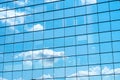 Reflection of the blue sky and clouds in the mirror wall of the city building Royalty Free Stock Photo