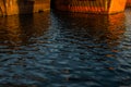 Reflection in blue water of old rusty brown red barges at sea in sunset light. Lake Baikal. Beautiful seascape Royalty Free Stock Photo