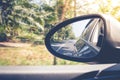 Reflection blurred roadway view on side mirror car during driving car on the way. Royalty Free Stock Photo