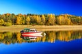 Reflection of boat and colorful autumn tress on water surface Royalty Free Stock Photo