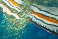 Reflection of a boat at sunset as a liquid abstraction