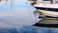 Reflection of boats laying in a marina at Larnaca, Cyprus. Blue sky and sea background. Royalty Free Stock Photo