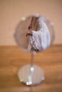 Reflection of the bride`s beige shoes in the mirror. Indoor Royalty Free Stock Photo